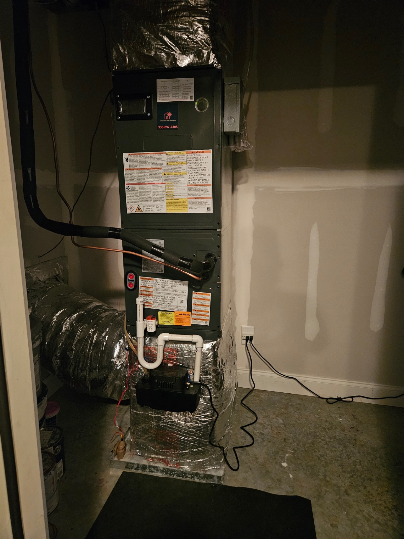 Vertical indoor air handler with insulated ductwork and condensate piping